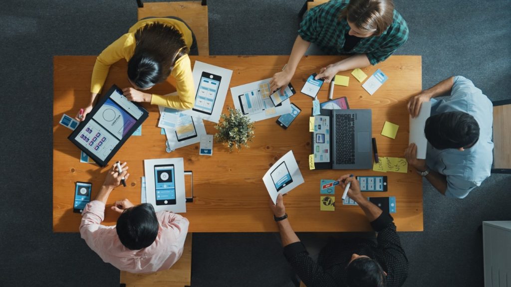 persone che stanno lavorando a un progetto su una scrivania 